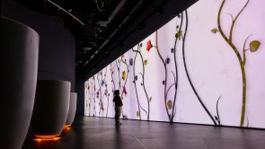 XYZ-Technologies-SZGMC-Light-and-Peace-museum-A-child-infront-of large-illuminated digital-display-featuring-stylized-floral-patterns